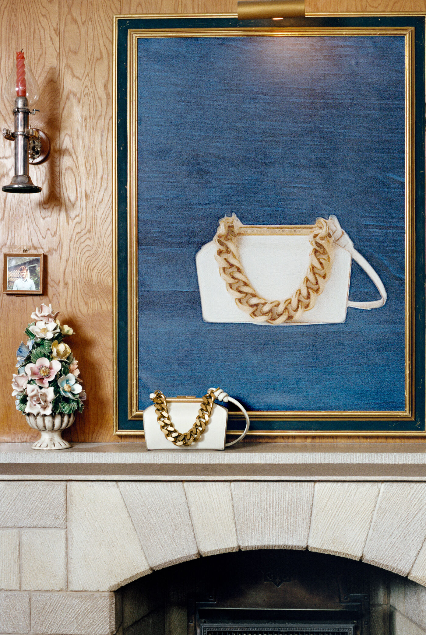 Fireplace with Gold chain white Falabella bag on mantel piece  Fireplace with Gold chain white Falabella bag on mantel piece